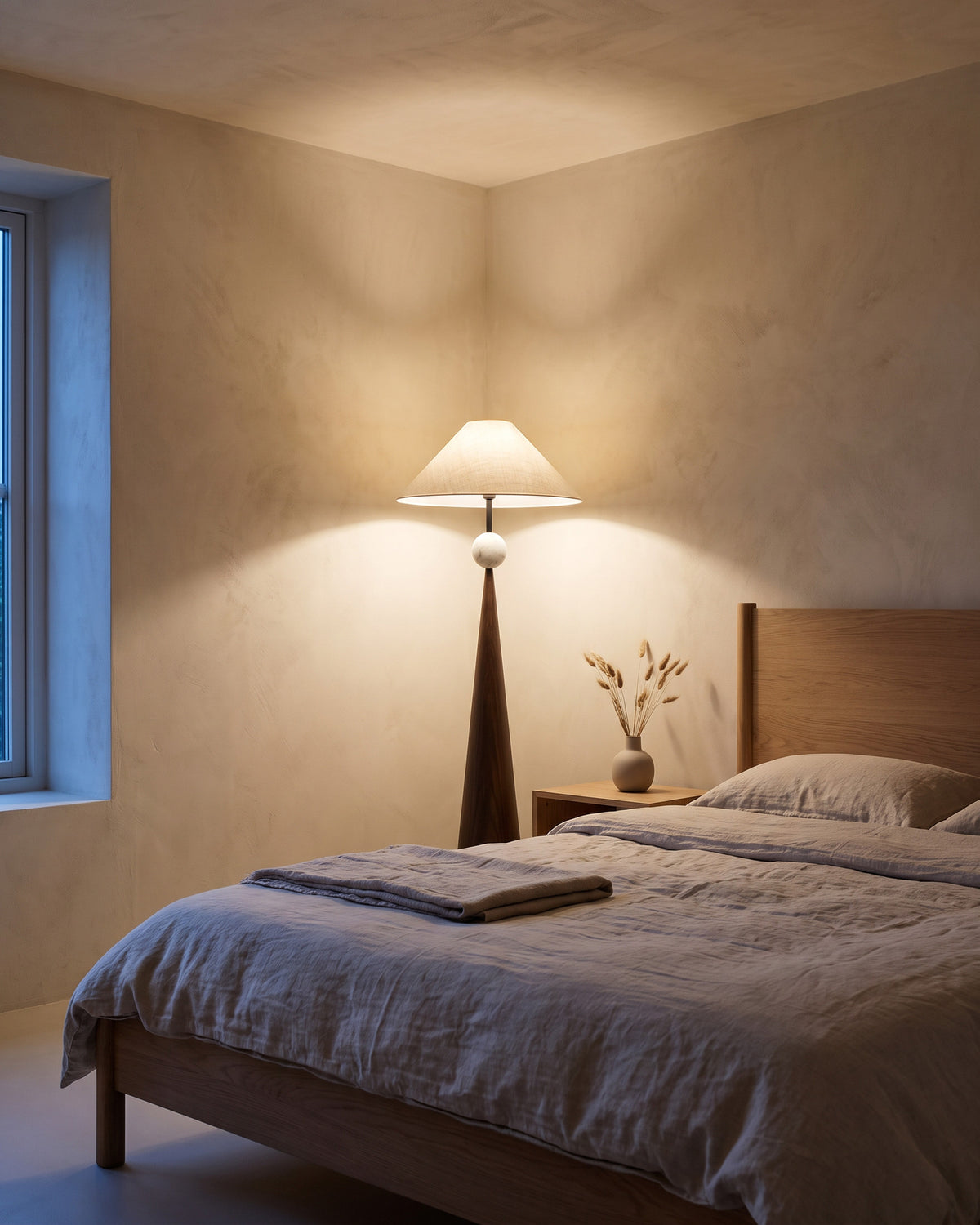Lampadaire Obélisque, abat-jour plissé et perle dorée, dans une chambre, en soirée
