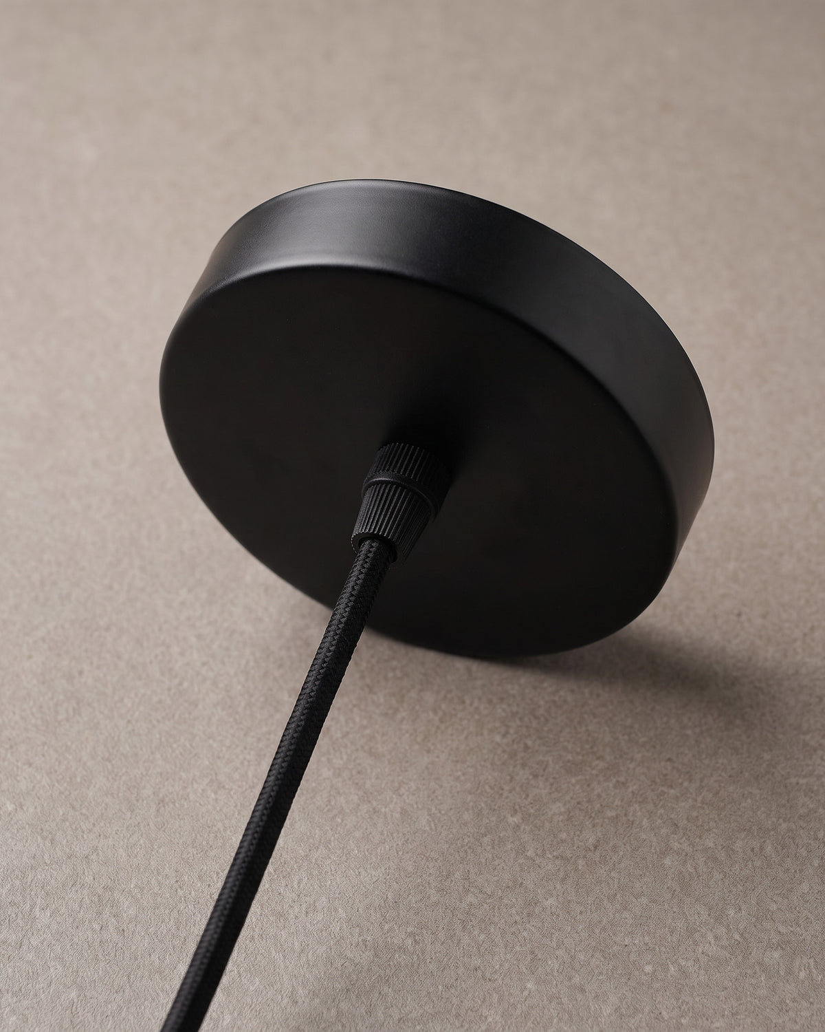 Suspension Natte : détail, la douille noire au sommet et la rosace ronde noire