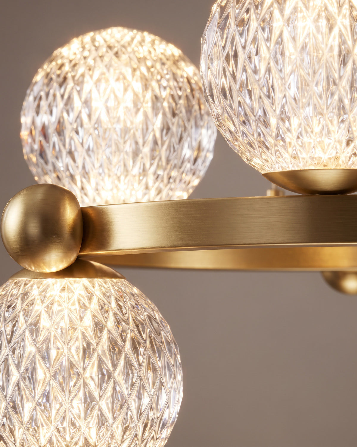 Lustre Orbe : gros plan sur les globes texturés et l'anneau finition laiton
