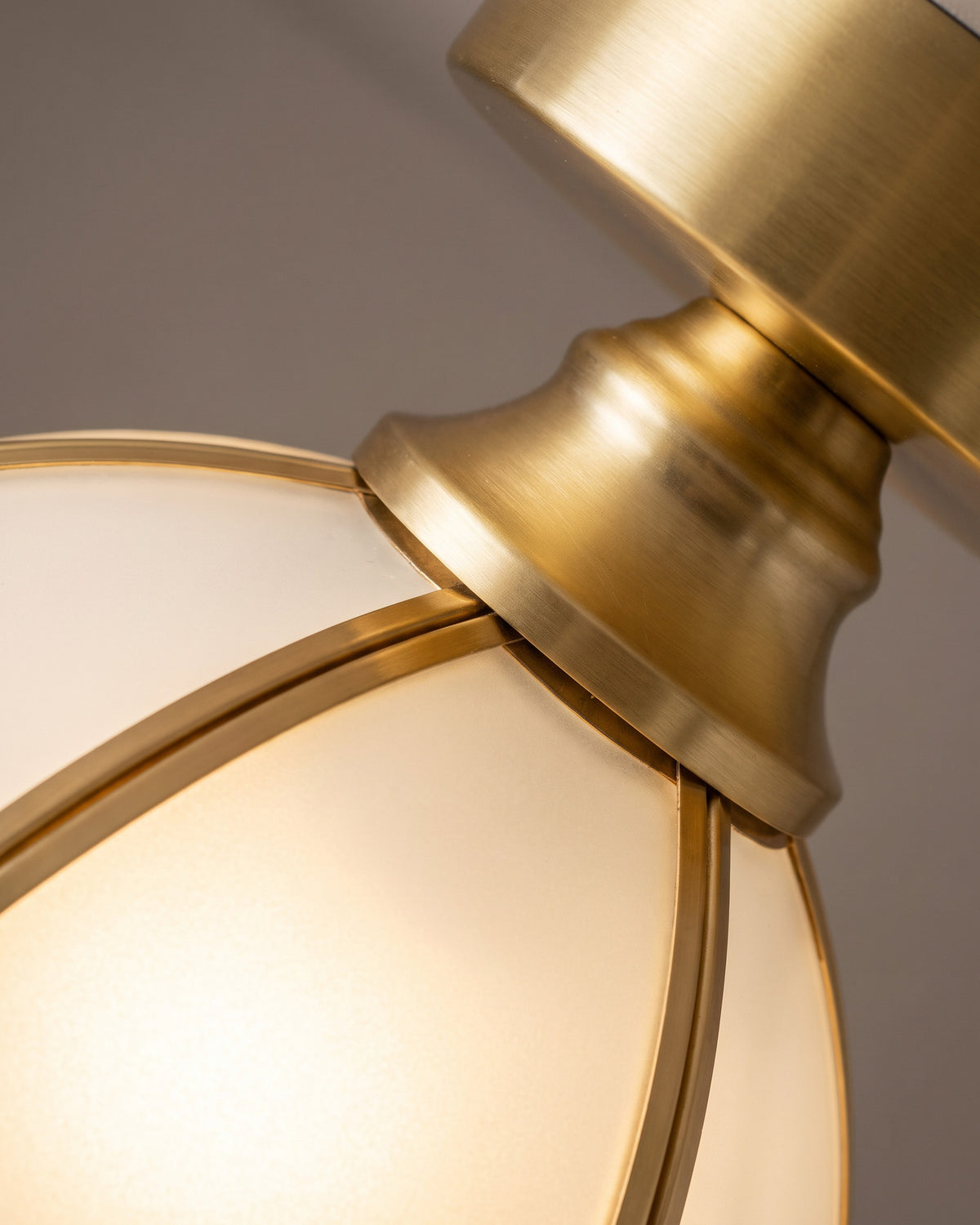 Plafonnier Tulipe : gros plan sur la matière (verre blanc et métal doré)